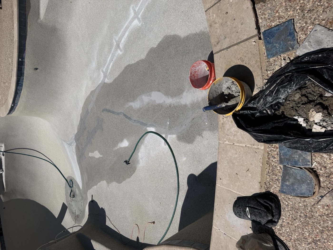 Drained pool floor mid-repair
