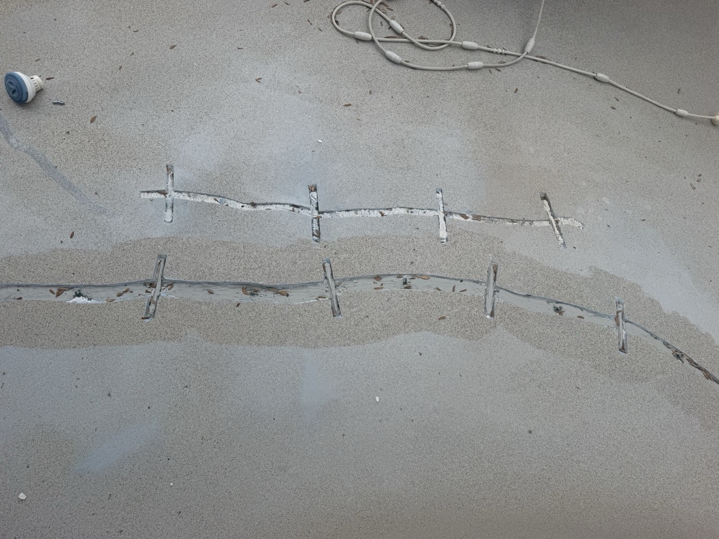 Stitch crack repair on a pool floor